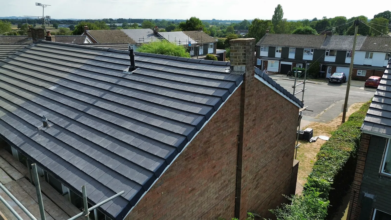 Completed grey tiled roof by Stanley & Son Roofing, aerial view over Buckinghamshire
