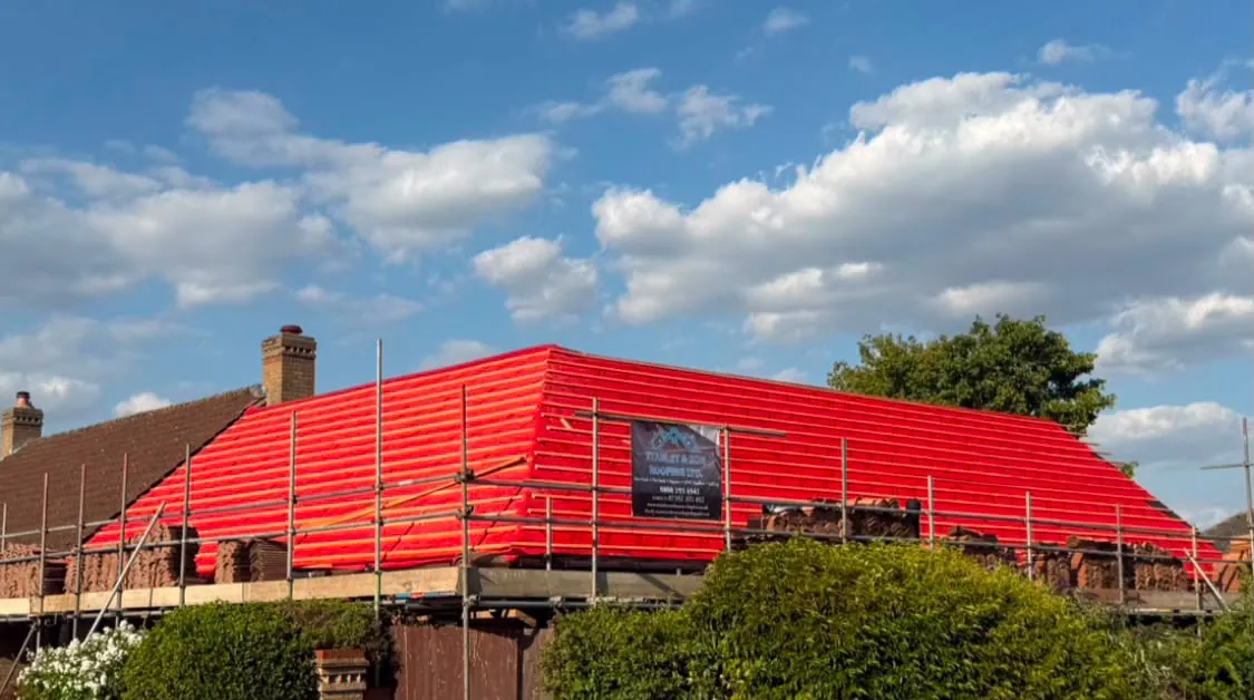 New roof with the Stanley & Son site board on the scaffold